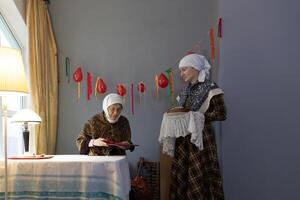 Two women standing next to a table photo