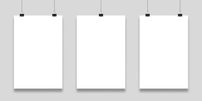 Three blank white papers are hanging on a gray wall, held by black binder clips, providing a clean and professional backdrop for displaying artwork or announcements vector