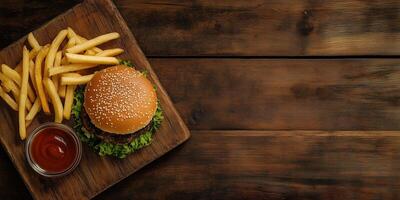 Burger and fries side by side on a wooden board, gastronomy photography photo