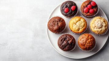 Top-down view of muffins on a round white plate, food setting photo