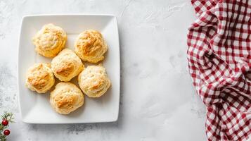 Top-down view of scones on square white plate, meal photography photo