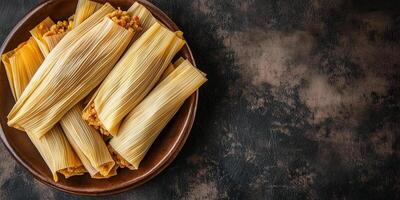 Top-down view of tamales with corn husks wrapped around the filling, neatly arranged on a dish, meal photography photo