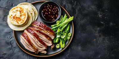 Peking duck with scallions and hoisin sauce, food setting photo
