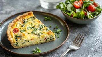 Plate with quiche slice, small salad bowl, and fork on the side, meal photography photo