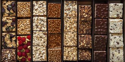 Box of meal replacement bars arranged neatly in rows with clear labeling, gastronomy photography photo