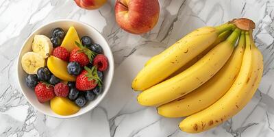 Bunch of bananas on a kitchen table next to a bowl of mixed fruits, meal photography photo