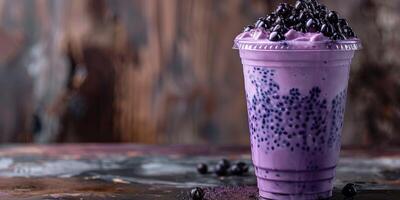Plastic cup filled with purple taro-flavored drink, topped with black tapioca pearls, food setting photo