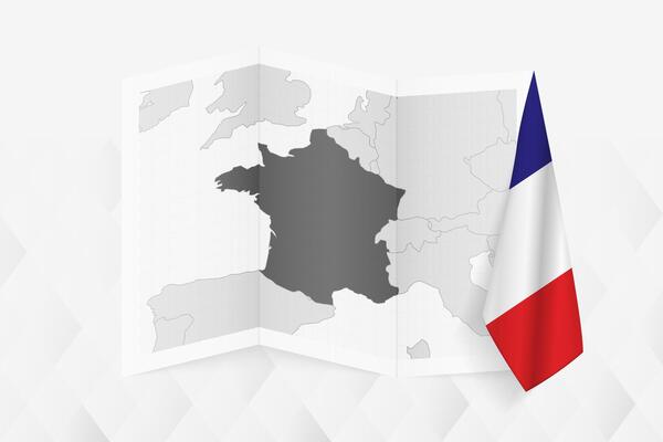 A grayscale map of France with a hanging French flag on one side. Map for many types of news.