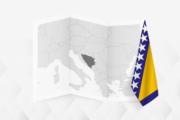 A grayscale map of Bosnia and Herzegovina with a hanging Bosnian and Herzegovinian flag on one side. Map for many types of news.