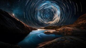 mesmerizing starry night sky captured with mirrorless camera, showcasing swirling star trails over tranquil water body surrounded by rocky terrain. scene evokes sense of wonder and serenity photo