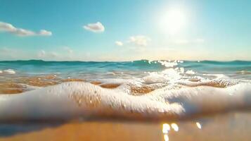 serene beach view with gentle waves lapping at shore under bright sun. clear blue sky and sparkling water create tranquil atmosphere photo