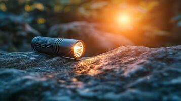 A flashlight is sitting on a rock photo
