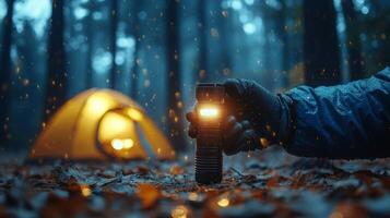 A person holding a flashlight in the woods photo