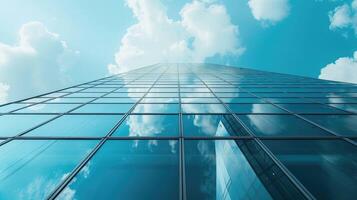 A building with glass windows and clouds in the sky photo