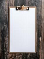 blank clipboard on wooden background photo