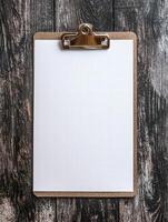 blank clipboard on rustic wooden background photo