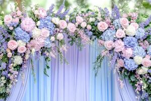 Elegant wedding arch adorned with pastel flowers and drapery in a serene outdoor garden setting photo
