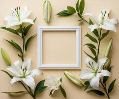 White lilies surrounding empty frame on beige background photo