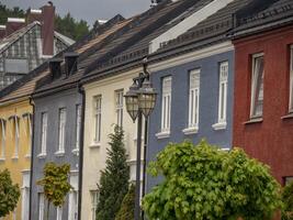 A row of houses with a street lamp in front of them photo