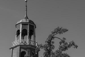 A black and white photo of a clock tower