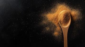 Spoon of maca powder on black background. Superfood concept. photo
