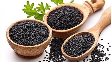 Black Sesame Seeds in Wooden Bowls and Spoons photo