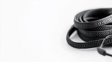Black shoelaces rolled up on white background photo