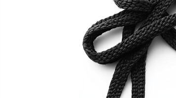 Black shoelace on white background. Minimalist textile texture. photo