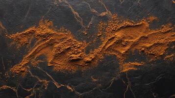 Cinnamon powder on dark background. Spice, food, texture concept. photo