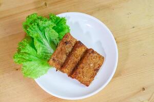 Tempe bacem is a processed tempe that comes from Central Java. Has a distinctive sweet taste because it uses palm sugar. Actually baceman is a technique of preserving food naturally. photo