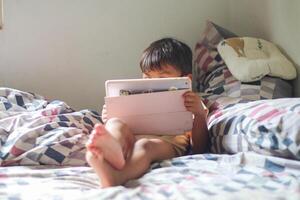 Kids with tablet computer. Child with pc watching movie or playing game. Educational online program for school child. Boy with digital device and gadget. Screen time and education for young kid. photo