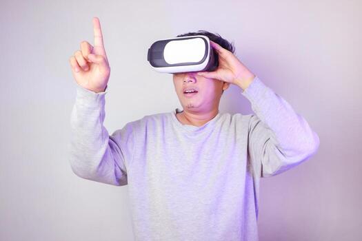 asiático hombre desarrollando industrial producto con computadora interfaz y vr lentes. Ingenieria técnico fabricación componente utilizando interactivo auriculares para Ciencias y industy producción. foto