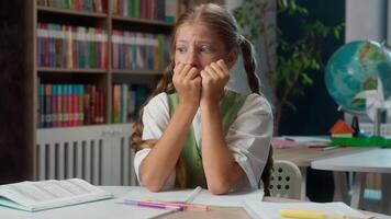 Scared worried anxious Caucasian little girl fearful frightened school child kid nervous pupil schoolgirl student primary education learner biting nails afraid fail test exam worry problems classroom video
