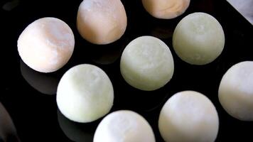 Multi-colored Japanese Mochi ice cream in rice dough and different fillings and tastes. Traditional Japanese video