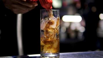 Cola add Cola to rum and ice alcoholic cocktail with ice, dark rum, lime and coca cola. adding soda to highball video