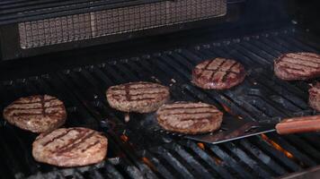 Commercial Style Super Slow Motion Footage with an Anonymous Chef Flipping Burger Meat on a Flame Grill. Close Up of a Tasty Beef Patty is Being Cooked in a Restaurant video