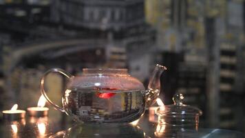 red hibiscus tea ball bomb. Small portioned handmade ball bomb with dried lemon slice, green herbal tea in glass cup, rotating top view video