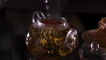 green tea in a glass teapot making green tea in a glass teapot with lemon and mint, transparent teapot with mint, lemon, ginger and green tea video