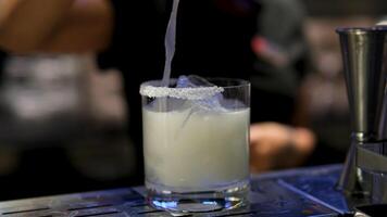 Cooking process Step by step Close up of a professional bartender is mixing gin tonic with professional crystal ice cubes to customers at the bar or disco club. video