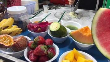 Close up view the special ice-cream spoon is scooping a delicious fresh strawberry ice cream . High quality video