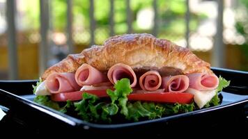 Ultra macro view of croissant with ham, lettuce and cheese, healthy breakfast video