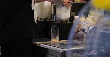 Worker at food factory preparing ice cream using a professional blender in bucket mixing cold cream. Handmade preparing ice cream. video