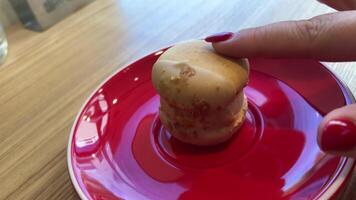 Cup of coffee with macaroons on red background. video