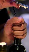 Opening bottle of wine with an electric corkscrew. Electric device corkscrew for alcohol. video