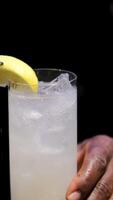 Bartender working, beautiful row line of different coloured liquor alcohol cocktails on a open air party in a bar, and others on catering banquet on event, barman mixing drinks and beverages in club video
