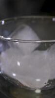 Throw ice cubes in empty glass. Ice Cubes falling down in empty transparent glass. Make a fresh drink. Footage b roll scene 4k. Slow motion. video