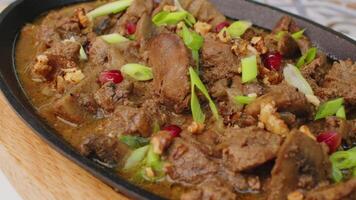 Beef stew in frying pan on table, close up view video