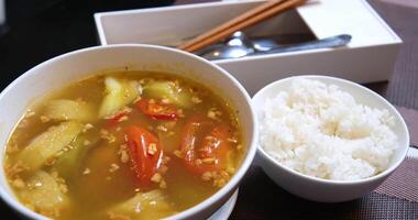 Ladling soup into a bowl at table video