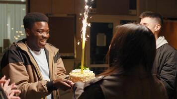 A joyful birthday celebration with cake and sparkler in the evening at a cozy venue among friends video