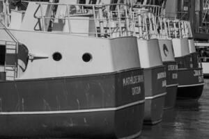 A group of boats docked in a harbor photo